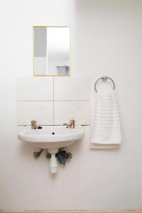 a bathroom with a sink and a mirror at Tasha Coastal Accommodation in Walvis Bay