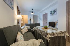 ein Wohnzimmer mit Sofa und Tisch in der Unterkunft Paco del Molino 2 in Grazalema