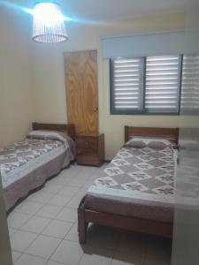 En eller flere senge i et værelse på Casa centrica turistica