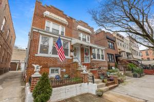 a brick house with an american flag on it at Impeccable 1BR unit in Brooklyn in Brooklyn