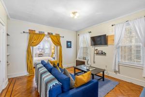 a living room with a blue couch and a table at Impeccable 1BR unit in Brooklyn in Brooklyn