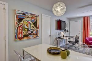 a kitchen with a table and a painting on the wall at Spacious condo with easy access to Uptown in Charlotte