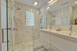 a bathroom with a glass shower and a sink at Spacious condo with easy access to Uptown in Charlotte