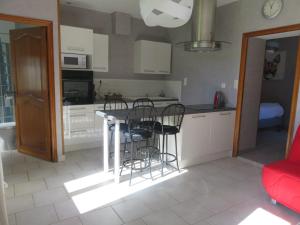 a kitchen with a table and chairs in a room at Auberge a la Ferme in Surques