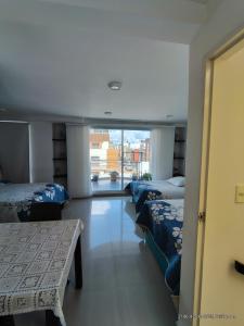 Ένα ή περισσότερα κρεβάτια σε δωμάτιο στο Hospedaje en casa familia +6 φωτογραφίες