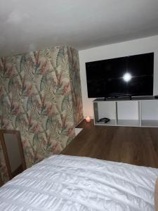 une chambre avec un lit et une télévision à écran plat dans l'établissement 63 Spellow Lane, à Liverpool 17 autres photos