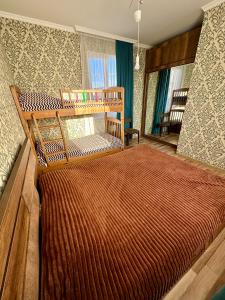 a bedroom with a large bed in a room at Holiday house Tbilisi in Tbilisi City +5 photos