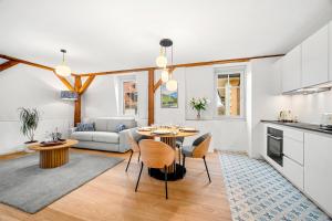 a kitchen and living room with a table and chairs at La Suite du Bourg in La Tour-de-Peilz