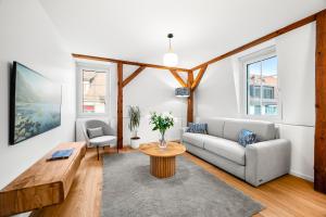 a living room with a couch and a table at La Suite du Bourg in La Tour-de-Peilz