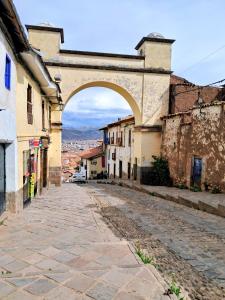 an archway over a street in an old town at HOSTAL La RASA in Cusco