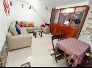 a living room with a couch and a table at HOSTAL La RASA in Cusco