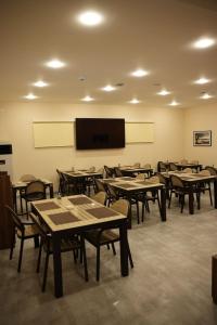 a classroom with tables and chairs and a flat screen tv at LIFESPORT-Complex Hotel & spa in Əlǝt +117 photos