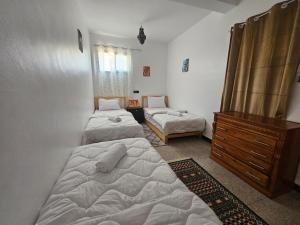 Giường trong phòng chung tại Welle Surf House