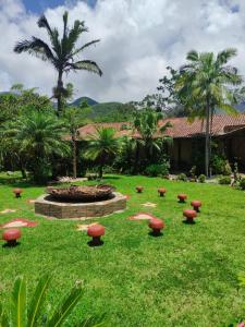 a garden with red mushrooms in the grass at Atelie Hospedagem in Palhoça