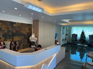 een lobby met een kerstboom en een kind dat aan een balie zit bij Hotel Sítio Novo in Piratuba +66 foto's