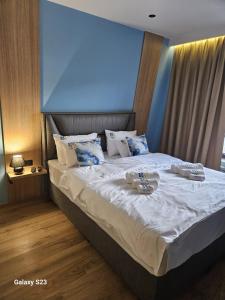 a bedroom with a large bed with two plates on it at Apartman Blue Sky in Jahorina +25 photos
