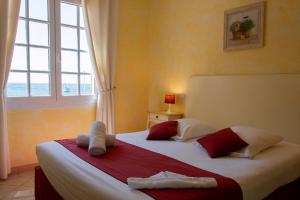 a bedroom with two beds and a large window at Hôtel & Spa La Villa in Sainte-Maxime +98 photos