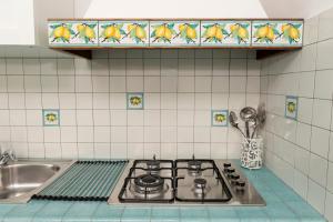 eine Küche mit Herd und Spüle in der Unterkunft Porta della costiera in Vietri