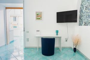 ein weißer Tisch in einem Raum mit einem Fernseher an der Wand in der Unterkunft Porta della costiera in Vietri + 44 Fotos