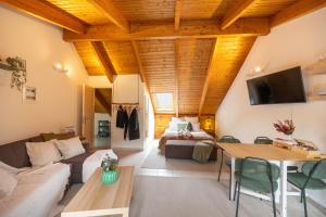 a living room with a couch and a bed at Rokani Sofita II in Kalavrita