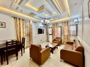 a living room with furniture and a dining room at Fadilimmo 009 in Yaoundé