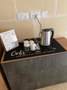 a counter with a tea kettle and cups on it at St Therese in Victoria