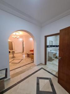 a living room with a door and a living room with a table at Appartement Domaine Du Soleil Hammamet 