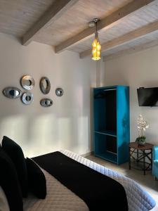 a bedroom with a bed and a blue cabinet at Hotel Boutique Rancho San Jorge in Bernal