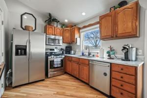 a kitchen with stainless steel appliances and wooden cabinets at Haven Oasis in Nampa