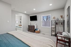 a bedroom with a bed and a flat screen tv at Haven Oasis in Nampa