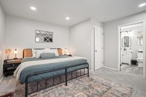 a white bedroom with a bed and a bathroom at Haven Oasis in Nampa