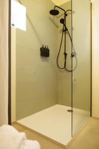 a shower with a glass door in a bathroom at Casa Dante in Putignano +13 photos