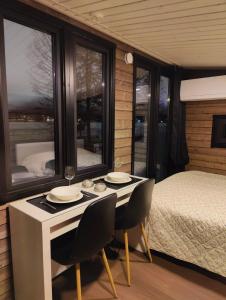 een slaapkamer met een bed, een tafel en stoelen bij The Little Owls Nest in Rovaniemi