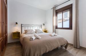 ein Schlafzimmer mit einem großen Bett mit zwei Kissen darauf in der Unterkunft Paco del Molino in Grazalema