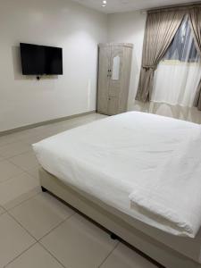 En eller flere senge i et værelse på رايز النسيم للشقق المخدومة