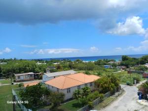 an aerial view of a house with the ocean in the background at Modern studio apartment near beach in Saint James