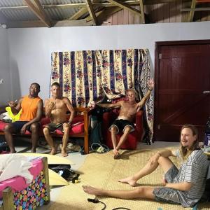 a group of people sitting in a room at Surf stay cloudbreak in Nadi