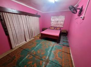a room with a pink room with a bench at Surf stay cloudbreak in Nadi