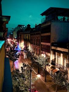 a view of a city street at night with lights at Hostal KEMMM in Mexico City