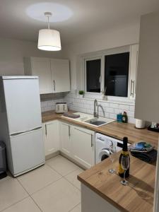 Il comprend une cuisine équipée d'appareils électroménagers blancs et d'un réfrigérateur blanc. dans l'établissement Rowe Terrace Workington, à Workington 5 autres photos