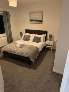 une chambre avec un grand lit et une chaise dans l'établissement Rowe Terrace Workington, à Workington