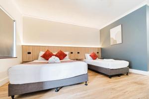 Postel nebo postele na pokoji v ubytování Country 2 Coast Motor Inn Coffs Harbour + 87 fotografií