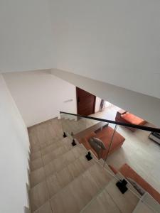 a room with a staircase with a glass table at DjossayaHomes in North Legon +116 photos