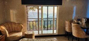 a living room with a large window with a view at LvL 50 in Murree
