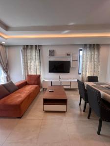 a living room with a couch and a table at DjossayaHomes in North Legon
