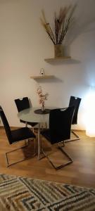 a dining room with a table and four chairs at Privat Appartment Room Martz Dorf in Vienna