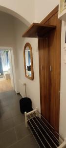 a living room with a mirror and a chair at Privat Appartment Room Martz Dorf in Vienna