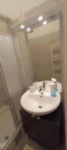a bathroom with a sink and a mirror at Privat Appartment Room Martz Dorf in Vienna +20 photos