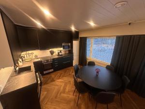 a kitchen with a table and chairs in a room at Apartment Alakorkalo in Rovaniemi +35 photos