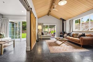 un soggiorno con un divano e un tavolo di Stone Cottage ad Arrowtown